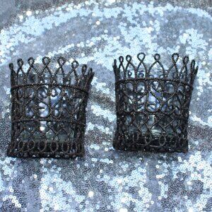 Two, small candle holders with glass holders inside. Crown type design with